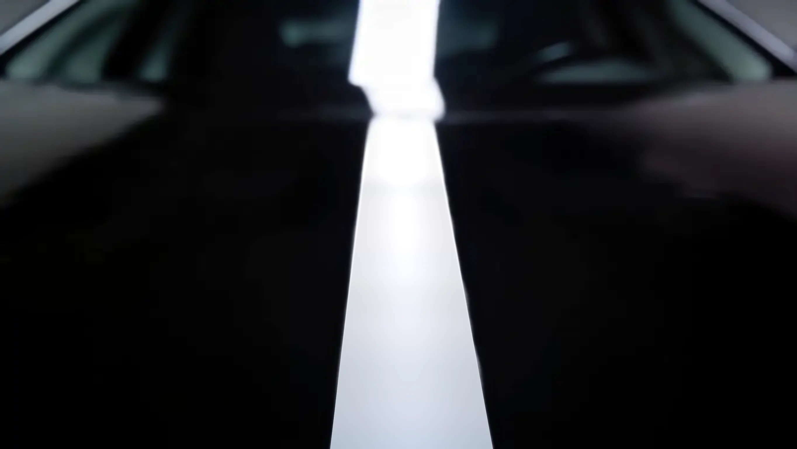 The clean hood with a single strip light reflected down it.