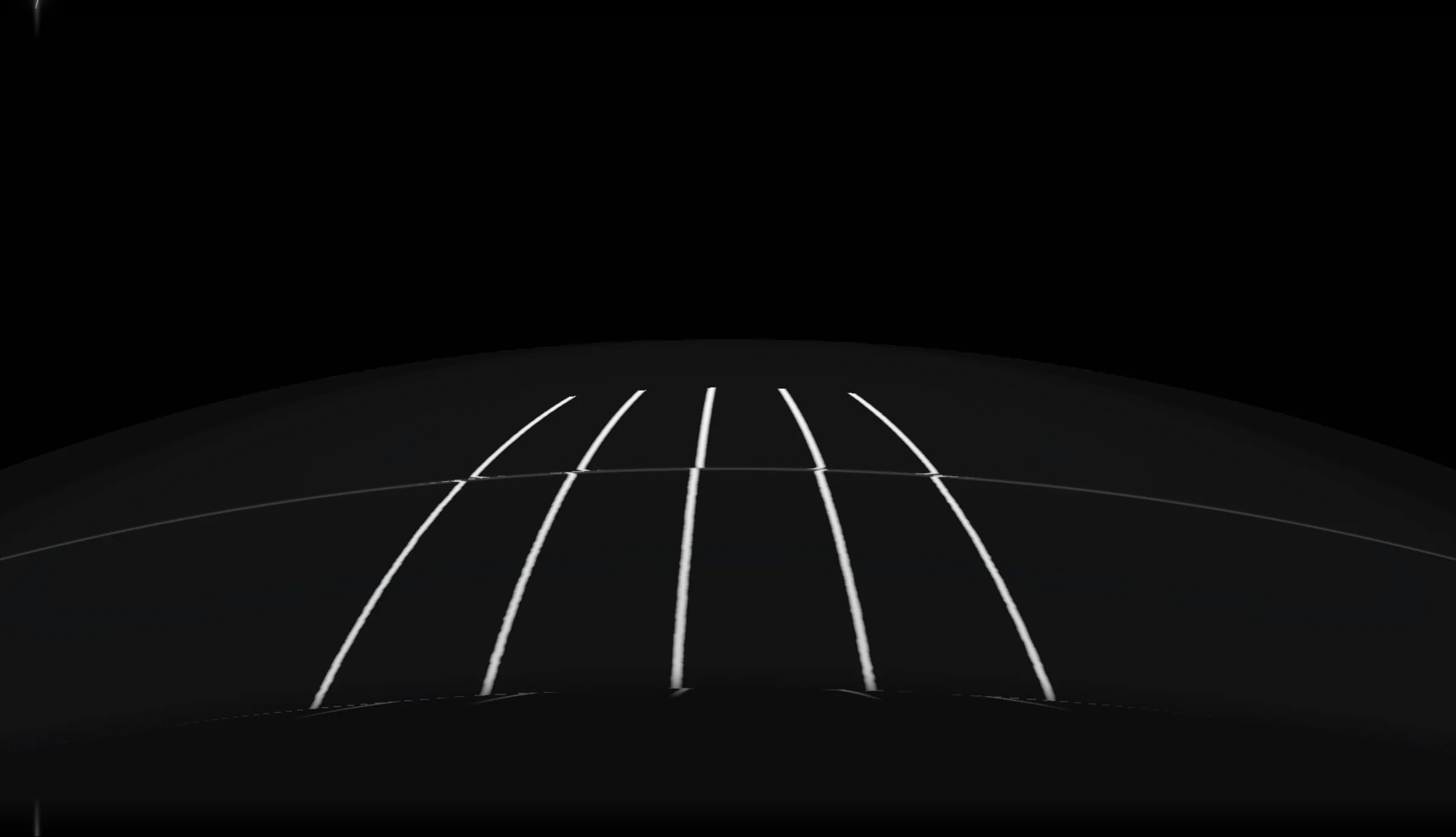 The front of a black hood in a dark studio. Film cut on the car leaves a line across it, and every reflection jogs where it crosses.